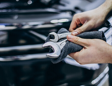 Hands holding workshop spanners