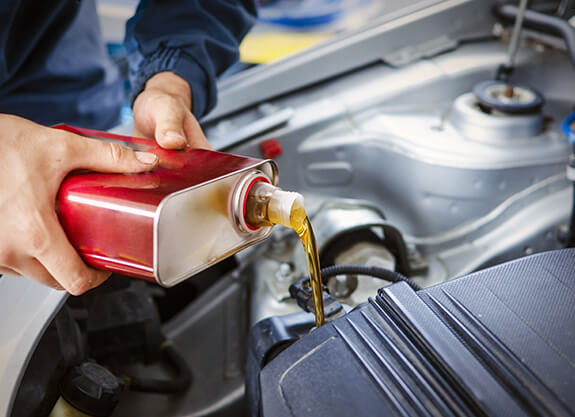 Engine oil being poured during vehicle servicing