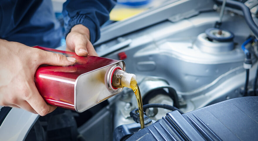 Engine oil being poured during vehicle maintenance